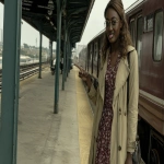 **during the Harlem renaissance An average-looking Nigerian lady with shoulder-length brown hair and horn-rimmed glasses stands on a railway platform in a knee-length, tan trench coat, open at the top to reveal a floral minidress, She is sticking out her tongue --c 87 --w 2098 --ar 16:9 --v 7.0** - Upscaled by <@1378873254177149010> (relaxed)