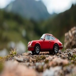 **a Porsche 911 Targa netsuke exaggerated forced perspective with minimal motion blur --ar 295:166 --style raw --s 250 --iw 2.5 --c 25 --q 2 --p x1ml6ks 7t7o6mb** - Image #3 <@1059634795207991457>