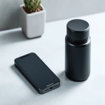 **close up photograph of an iphone 16 and a 6oz black plastic jar on a white counter top. the iphone is face-up and next to the black plastic jar. product shot, advertising, affiliate program --v 7.0 --ar 16:9** - Image #3 <@1061750239708577893>
