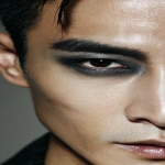 **full-face portrait of a fashionable 30-year-old Taiwanese man, long-shaped face, fair pale skin, thick eyebrows, large expressive double-lidded eyes, and naturally full lips, with softly contoured cheeks not sunken; styled with bold high-fashion smokey eye makeup in deep gray and black tones, paired with glossy lip color for a striking contrast; contemporary hairstyle with clean lines, cinematic editorial lighting highlighting makeup and hair details, blurred neutral background, sharp focus on facial features, refined fashion magazine aesthetic, no text, no watermark --ar 9:16** - Image #2 <@1090872516857299025>
