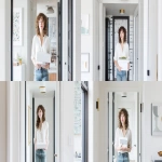 **realistic photograph of a woman wearing a white blouse and jeans, looking at camera with a confident expression. She is holding a white box. The dimensions of the box are 17.04 x 15.94 x 6.18 inches. She is standing in a small apartment living room, walls on both sides, brightly lit, the camera is at a low angle. --ar 16:9 --oref <https://s.mj.run/-7AyBy5lgj4> --ow 100 --sref <https://s.mj.run/7FKe0hD0cMc> --sw 100** - <@820114505819226165> (fast)