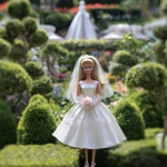 **a 1980’s Barbie doll standing in a wedding gown. The dress is a-line. The veil is simple and short. In the background is a beautiful manicured garden. Ultra realistic, highly detailed, photorealistic. HD --v 7.0** - Image #3 <@1327691479602298971>