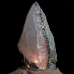 **on display. A random piece of crystal art in the style of Abstract Expressionism art period artists. This crystal has been cracked and broken. The large repair along the side of the quartz is of turquoise stone used to mend it. The base has patina copper and layered black rock. The base is adorned with carved magical sigils. High-end, high-quality cultural design. --c 85 --s 700 --w 450 --v 7.0** - Image #1 <@923747341717078036>