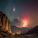 **Lunar Eclipse above a geomagnetic aurora lightning storm in the sierra desert, A cliffside wall very close by in the foreground --ar 16:9** - Image #1 <@1135636698060038216>