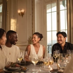 **Portrait of friends at a dinner table in a luxury apartment, French neoclassical style. They are between 39 and 45 years old, all wearing minimalist clothing in neutral tones, casually drinking wine. They are a diverse group: a dark-skinned Black woman wearing an elegant off-white dress with braided hair, an Asian man, and a white woman and man. The setting is a dining room with large windows, high ceilings, soft lighting, and a relaxed atmosphere.** - Image #4 <@1128428931243057244>