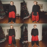 **A young handsome tan skinned white man with dirty blonde wavy short hair dressed in a Y2K Cholo gangster style, wearing a black long sleeve Dickies work shirt and extremely baggy, extra-long, 3XL plain long red and black Nike basketball shorts. His shorts are very long and go down to his ankles and feet. He is wearing Nike Cortez shoes in his house by a Christmas tree** - Variations (Strong) by <@1061360796438900746> (fast)