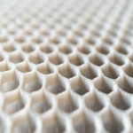 **Close-up of ceramic honeycomb catalyst substrate used in bioenergy emission control, shown in angled side view, perfect lighting on textured grid pattern, isolated studio scene, hyper-realistic and clean --ar 3:2 --v 6.1 --quality 2 --raw** - Image #2 <@1145244586088861708>