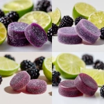 **close up photograph of 2 purple, round, quarter sized gummies. in the background are an assortment of lime wedges and blackberries on a solid white background** - <@1061750239708577893> (fast)