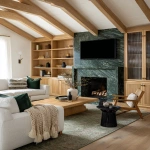 **editorial photo of a cozy moody traditional-modern living room with ribbed glass-fronted and oak ribbed shaker cabinetry with brass sleek cylindrical handles, an exotic forest green granite fireplace with bold veins, white modern sofa and accent chairs, large ribbed oak coffee table, beige knitted throw blankets and throw pillows, black ribbed round end tables, Natural oak plank flooring with a traditional light green rug, oak ceiling beams. ARRIFLEX 35 BL camera, high definition quality, Canon K35 Prime Lens, bright and airy --ar 4:5 --raw** - Image #3 <@1230559318680670299>