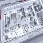 **exploded view of an interstellar welding experience kit laid out in a cleanroom-grade modular case, containing TIG welding torch with articulated gimbal mount, tungsten electrodes in vacuum-sealed pods, brushed stainless steel test panels, compact argon gas recycler with carbon capture ring, digital weld control interface with haptic feedback knobs, auto-darkening visor with atmospheric readouts, pressure-regulated gloves and insulation sleeves, microgravity alignment clamps, magnetic grounding matrix, illuminated setup under sterile white lighting, Martian red dust visible on outer shell, environment reads as pressurized mobile fab station, cinematic ultra-detail, technical product photography style --ar 3:2 --q 2 --s 50 --p z4f83u2 --v 7.0 --raw** - Image #2 <@997245562065789039>