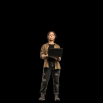 **a female software developer holding a laptop, wearing torn jeans, t shirt over long sleeve shirt, pure black background --sref <https://s.mj.run/YYNlkkGrAA0> --v 7.0** - Image #2 <@679709826716270628>