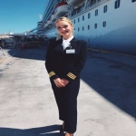**iPhone photo of a woman in a cruise ship crew uniform, 25 years old, beautiful, full-length --ar 3:4 --s 50 --raw --v 7.0** - Image #2 <@1264344222698307735>