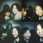 **This is a realistic, but blurry, out-of-focus, and grainy, color photograph. It was taken in a classroom (likely a Japanese junior high school) and shows two female students. The student on the right has wavy, shoulder-length black hair and a broad smile. The student on the left is only partially visible, her black hair short, and only part of her face is visible within the frame. A blurry figure is faintly visible in the background, behind and between the girls. The figure's face is largely blurred and indistinct, and its expression is dark and shadowed, making it difficult to discern. This suggests a sinister or ghostly presence. The background is somewhat dark and out-of-focus, suggesting a dimly lit classroom. A light from the front clearly illuminates the smiling cheeks. The overall atmosphere in the foreground is casual and friendly, but the dark, face-filled figure in the background subtly creates an unsettling and mysterious atmosphere. This is a realistic, blurry, out-of-focus, and very grainy color photograph. --v 7.0** - <@1036285603907633172> (relaxed)