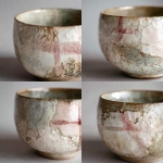 **Photorealistic close-up of an elegant handmade ceramic cup, inspired by nature and calmness, organic shape, soft textures, subtle imperfections, gentle pastel color palette (muted beige, soft sage, pale blush), matte-to-silk glazed surface. A soft, realistic reflection of the Danish flag (red and white cross) visible in the glaze, subtle and abstract, not literal or dominant. Scandinavian aesthetic, natural diffused daylight, minimalistic composition, shallow depth of field, ultra-high detail, realistic shadows, professional studio photography 16:9 raw --v 7.0** - Variations (Strong) by <@1062788114764013599> (fast)