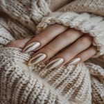 **champagne velvet chrome nails, soft satin-like finish, cozy luxury manicure, warm golden undertones, photographed with winter knits and natural light, cashmere textures, hands posed gracefully, subtle elegance --v 6.0 --ar 2:3 --raw** - Image #1 <@1321895242076520463>