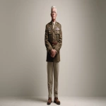 **Full body photo-realistic portrait of an older retired United States Army veteran medic, standing proudly at attention on a pristine white seamless backdrop. He wears an authentic, impeccably detailed Army medic dress uniform from recent decades, complete with badges, insignia, and decorations; visible signs of age and experience in his weathered hands and face, dignified expression, neatly groomed hair, polished boots. High-resolution photography style, soft even studio lighting with subtle shadows for depth, neutral clean color palette focused on the uniform’s olive and brass tones, crisp camera angle, sharp focus throughout, minimal background distractions for emphasis on subject, professional editorial composition. --v 7.0 --ar 16:9 --q 2 --stylize 200 --no text, watermark, noise, blur, cropping errors** - Image #2 <@912147079541981205>