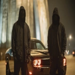 **2 St. Louis Based Rappers, wearing all black, black masks and hoods, gloves, up close and personal 8k professional photography shoot for an album cover, low light night time dynamic and cinematic. Under the Gateway Arch Standing by a black Trackhawk and a black Hellcat --ar 16:9 --v 7.0 --raw** - Image #3 <@1060379121521279086>