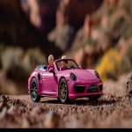 **Barbie and Ken netsuke cruising around in Barbie's pink Porsche 911 Convertible, exaggerated forced perspective --ar 295:166 --style raw --s 250 --iw 2.5 --c 25 --q 2 --p x1ml6ks 7t7o6mb** - Image #1 <@1059634795207991457>