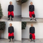 **A young handsome tan skinned white man with dirty blonde wavy short hair dressed in a Y2K Cholo gangster style, wearing a black long sleeve Dickies work shirt and extremely baggy, extra-long, 3XL plain long red and black Nike basketball shorts. His shorts are very long and go down to his ankles and feet. He is wearing Nike Cortez shoes in his house by a Christmas tree** - Variations (Strong) by <@1061360796438900746> (fast)
