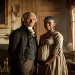 **Old Thomas Jefferson with flat white hair and short fringe, and a pregnant beautiful, part African Sally Hemings at the ornate Monticello mansion, late 18th century, standing in a softly lit interior with period-accurate clothing, looking at camera, Jefferson in refined colonial attire, Hemings in modest dress of the era, Old Thomas Jefferson and beautiful Sally Hemings, warm natural window light, nuanced expressions, dignified and respectful tone, historical realism, rich decor, photography, aesthetics, high resolution. --ar 4:5 --v 7.0 --no smiles** - Image #2 <@1121132320154452121>