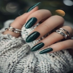 **hunter green almond nails, glossy rich finish, minimal rings, cozy fashion styling with sweater textures, clean background --v 6.0 --ar 2:3** - Image #3 <@1321895242076520463>