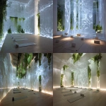 **Immersive, light-box yoga space. The entire room is a glowing white translucent screen, walls and ceiling are continuous danpalon panels. Deeply diffused, hidden uplights create a boundless white ambient light. Dynamic natural light-and-shadow patterns (like rippling water or subtle foliage) are projected and diffused across all surfaces, making the interior feel like a projection chamber or a world of pure light. There are strategically placed facade openings that offer glimpses of lush exterior planting, and vibrant greenery cascades down from subtle openings in the ceiling. The floor is made of warm, light-toned timber, and several neatly rolled yoga mats are subtly placed throughout the space, ready for use. Conceptual architecture, light art installation. --ar 16:9** - <@1009236404234092586> (fast)