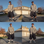 **A young handsome tan skinned white man with light brown hair cut short in a wavy shaggy hairstyle dressed in a Y2K Cholo gangster style, wearing a long sleeve flannel button up tan and white work shirt and extremely baggy, extra-long, 3XL plain long black white and blue Jordan basketball shorts. His shorts are very long and go down to his ankles and feet. He is wearing Nike Cortez shoes standing in his house in the winter --v 7.0** - Variations (Strong) by <@1061360796438900746> (fast)