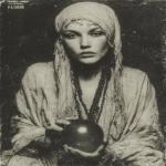 **1920 woman sitting in a robe holding a prophetic iris ball of crystal, exaggerated dark makup in the eyes, staring the camera, very old ferrotype crackled borders photography, in the style of ritualistic masks, vaudeville presentation, contemporary ferrotype photography, wiccan, indian scenes, 1920s --ar 87:112 --stylize 750 --v 7.0** - Image #1 <@1054482006731395092>