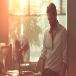 **office worker in a rolled-up sleeve shirt, sweaty, sitting at a desk in a modern office during a heatwave, standing fan nearby, intense sun shining through the window, scorching heat outside, daylight illumination, photorealistic style, warm and slightly muted color palette, soft sunlight glow --ar 16:9 --v 7.0 --q 2 --s 50 --p puravvo --raw** - Image #2 <@908777820459794493>
