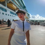 **iPhone photo of a woman in a cruise ship crew uniform, 25 years old, beautiful, full-length --ar 3:4 --s 50 --raw --v 7.0** - Image #1 <@1264344222698307735>