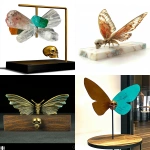 **on display 1 Art suprematism and abstraction movement art design, a surrealist art style base that contains a natural crystal point a watchful Zdzisław Beksiński style butterfly sculpture. With a gold small skull creature that is included in the body of the creature that has direct lighting and an angled side view. The wings have a natural look in coloured acrylics with turquoise and flat brass. Cultural and creative product design, high-end, high-quality. --c 5 --s 700 --w 450 --v 6.1 --ar 4:5 --q 2** - <@923747341717078036> (fast)