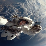 **The photo should be hyperrealistic but with distorted proportions. The framing should distort the proportions, prioritizing the head and shrinking the legs and feet. A 40-year-old female astronaut is on a spacewalk, having fun, smiling, and wearing a transparent helmet. In the background is planet Earth. She is holding a smartphone in her right hand and looking at the screen. Focus on the arm and the phone in the foreground. Use of a wide-angle lens. Natural light, surreal photo, crazy proportions. --ar 9:16** - Image #1 <@1310560084346146826>