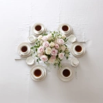 **simple, yet elegant tabletop, view is looking down on it, elegant ivory linen tablecloth, centerpiece of pink and white roses, six (6) steaming coffee cups symmetrically placed at each of the six (6) table settings --v 7.0** - Upscaled by <@1141845422852280493> (fast)