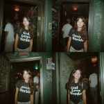 **a film photo of brunette Hispanic girl at the entrance of a club wearing a shirt that says "God Loves Weirdos"** - Variations (Strong) by <@1058622562147504138> (fast)