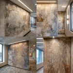 **A photo of an intricate, hand-painted wallpaper with faded gold and silver designs on the wall in an office building. The texture is rough concrete with visible sanded edges. There's an LED light bar above it that casts a soft glow over its surface. A windowless corner wall is on one side. In the background, there's another wallpaper design that looks similar but less detailed. It has more colors and patterns. The room also features white square lighting fixtures on the walls, creating subtle shadows on the ceiling. --ar 32:23 --v 7.0** - <@1313000520759377972> (fast)