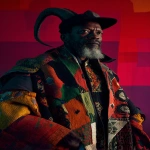 **a portrait of an african man with curled horns and thick beard, draped in garments stitched from vivid flags and bold banners, textiles patterned with geometric insignias, studio photography, by richard avedon, on a vibrant colored backdrop, hasselblad x2d 65mm lens, vexillopunk aesthetic, emblematic motifs, graphic contrasts --ar 85:128 --v 7.0 --p mwpi95x** - Image #4 <@451473582770618389>