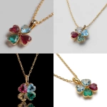 **Realistic image of a polished yellow gold necklace with a delicate chain and a four-leaf clover pendant. The first and second petals are heart-cut rubies, the third petal is a heart-cut aquamarine, and the fourth petal is a heart-cut emerald. The image has high resolution and lighting that enhances its beauty.** - <@1369435329731362987> (fast)