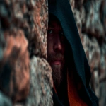 **cinematic image movie scene of a man in a fantasy cloak hiding behind a stone wall, dark blues and orange --ar 16:9** - Image #3 <@472489791414337556>