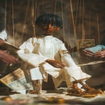 **A finely crafted marionette of a young anime boy with jointed limbs and visible strings, dressed in ancient Egyptian white robes. He is posed as if sitting at a table, controlled from above. Surrounding him, shadowy, out-of-focus figures of people manipulate stacks of money and scattered Roman coins. The boy, a puppet, has large, glassy, expressive eyes. The style is reminiscent of classic manga cover art, with the sharp lines and vibrant colors of the marionette contrasting against a darker, more theatrical background. --ar 85:128 --v 7.0 --p mwpi95x** - Image #1 <@451473582770618389>