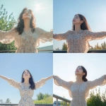 **A young and beautiful Korean woman standing outdoors, arms spread wide, basking in the warm sunlight. She is wearing a light floral-patterned blouse, exuding joy and a carefree spirit. The background includes a clear blue sky, subtle greenery, and a simple railing, emphasizing a sense of openness and freedom. The atmosphere is uplifting, natural, and serene, with soft lighting enhancing her youthful and vibrant appearance. Cinematic and realistic style. --v 6.1** - <@656836270752006172> (fast)