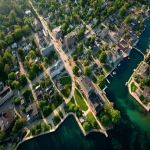 **aerial view of small town waterfront community with historic buildings, green spaces, and residential neighborhoods, Ontario Canada, planning map overlay, professional documentary photography style --ar 4:3** - Image #3 <@794327127260266516>