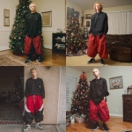 **A young handsome tan skinned white man with dirty blonde wavy short hair dressed in a Y2K Cholo gangster style, wearing a black long sleeve Dickies work shirt and extremely baggy, extra-long, 3XL plain long red and black Nike basketball shorts. His shorts are very long and go down to his ankles and feet. He is wearing Nike Cortez shoes in his house by a Christmas tree** - <@1061360796438900746> (fast)