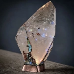 **on display. A random piece of crystal art in the style of Abstract Expressionism art period artists. This crystal has been cracked and broken. The large repair along the side of the quartz is of turquoise stone used to mend it. The base has patina copper and layered black rock. The base is adorned with carved magical sigils. High-end, high-quality cultural design. --c 85 --s 700 --w 450 --v 7.0** - Image #4 <@923747341717078036>