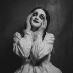 **a black and white photo-realism of a young girl, in ragged white dress, and heavy, dark makeup. she i. she is looking upwards, with her fingers in her eye sockets and grinning. eerie, unsettling. --v 7.0** - Upscaled by <@376196082390138880> (fast)