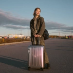 **<https://s.mj.run/2J3G2E0ob70> Geomagnetic storm. A 18-year-old female model, dressed fashionably, with a smile on her face, behaving gracefully, her hair neatly combed, carrying a suitcase in her hand, is outside the airport.** - Image #4 <@1348821992492630036>