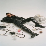**advertising shot of balenciaga, white background. a man wearing black and high boots is lying on the ground with his phone in hand, making a call while holding bags from balenciaga, surrounded by cables, coffee cups, and glasses. the scene was designed in the style of john galliano for vogue magazine. it's a masterpiece! --ar 9:16** - Image #4 <@1140324697154797598>
