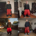 **A young handsome tan skinned white man with dirty blonde wavy short hair dressed in a Y2K Cholo gangster style, wearing a black long sleeve Dickies work shirt and extremely baggy, extra-long, 3XL plain long red and black Nike basketball shorts. His shorts are very long and go down to his ankles and feet. He is wearing Nike Cortez shoes in his house by a Christmas tree** - <@1061360796438900746> (fast)
