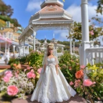 **a 1980’s Barbie doll in a wedding gown of satin and chiffon. The dress is mermaid style. The veil is simple and feminine. In the background is a beautiful gazebo. Ultra realistic, highly detailed, photorealistic. HD --v 7.0** - Upscaled by <@1327691479602298971> (fast, stealth)