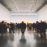 **Crowd of young artists and photographers in flashy modern art scene, one man walking calmly away, symbolic --ar 9:16 --raw** - Image #1 <@1355677392592441550>