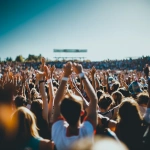 **wide angle sports crowd standing and cheering, shot from behind , day time, summer vibrant feeling, realism, Camera: DSLR - Canon EOS 5D Mark IV. Lens: Canon EF 24-70mm f/2.8L II USM** - Image #3 <@1252403463975866382>